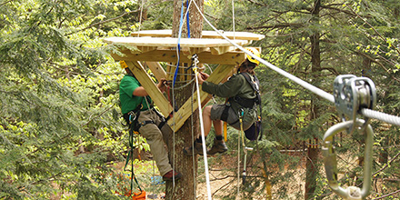 Aerial Adventure Park Builders hanging a platform